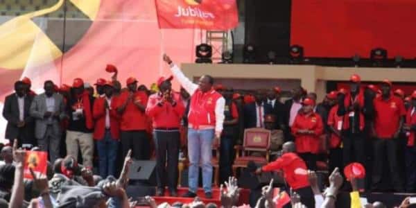 President Uhuru Kenyatta waves the Jubilee Party flag