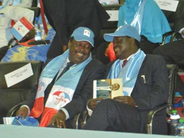 Amani leader Musalia Mudavadi chats with ODM boss Raila Odinga at Kasarani during Wiper Party NDC on Tuesday Photo/Eric Biegon