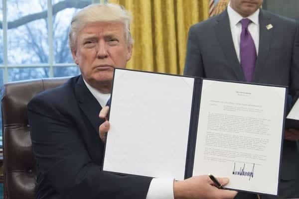 Trump pulls US out of Trans-Pacific Partnership deal: President Donald Trump holds up an executive order withdrawing the US from the Trans-Pacific Partnership after signing it in the Oval Office of the White House in Washington, DC, on January 23, 2017. PHOTO | SAUL LOEB | AFP