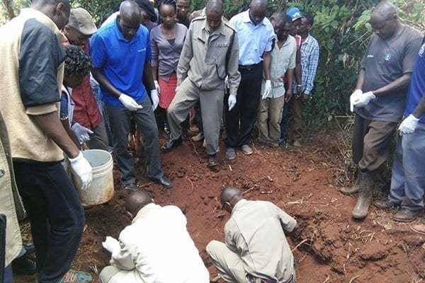 Police dig up the body of Mrs Grace Wangari