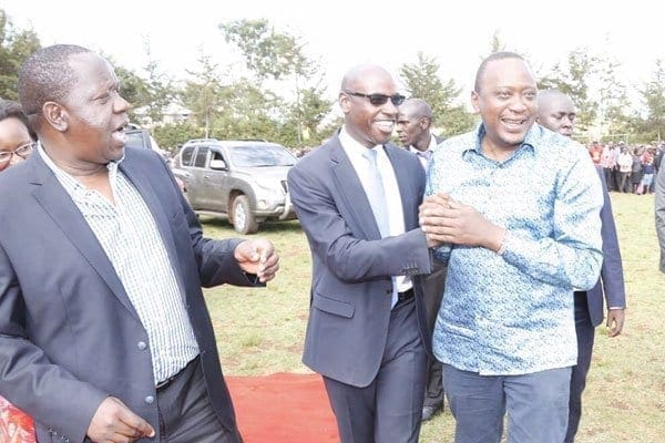 President Uhuru Kenyatta shares a light moment with Nairobi governor's director of communications Walter Mong'are and Education cabinet secretary Fred Matiang'i on March 22, 2017 Nyamira County. PHOTO | COURTESY