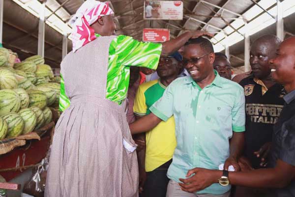 A trader at Jubilee Market in Kisumu blesses