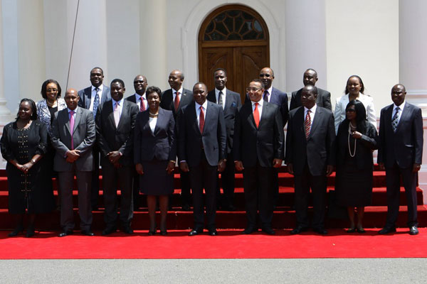 President Uhuru Kenyatta (centre), with the new Cabinet secretaries after their swearing-in ceremony at State House, Nairobi on May 15, 2013. PHOTO/STEPHEN MUDIARI