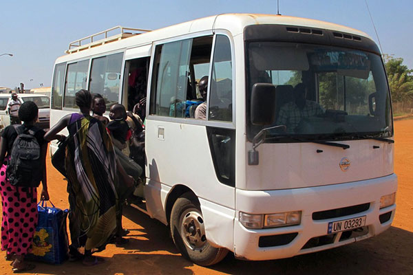 A handout photo released by the UNMISS shows people boarding a bus as they seek refuge in the UNMISS compound in Juba, on December 18, 2013. Four Kenyans are among hundreds of people injured following fighting in South Sudan due to Sunday’s coup attempt. AFP PHOTO / UNMISS / Rolla Hinedi
