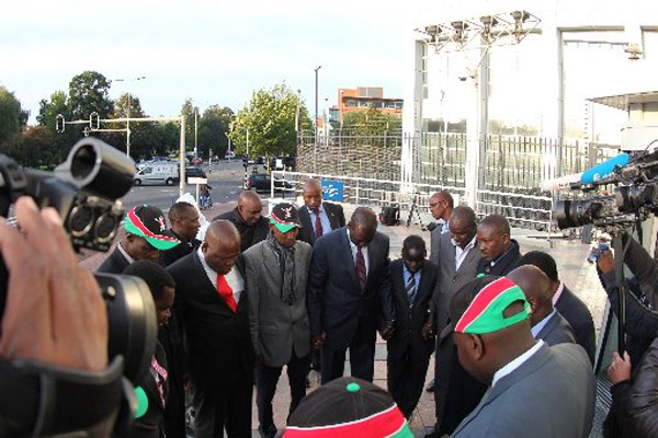 BILLY MUTAI| NATION MPs pray with Deputy President William Ruto and his co-accused, Mr Joshua arap Sang, outside ICC on October 2. Kenyan MPs have criticised civil society organisations for their stand against amendments on the Rome Statute to shield sitting heads of states from prosecution.