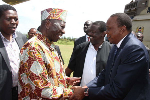 PHOTO | PSCU President Uhuru Kenyatta is welcomed by former Vice President Moody Awori on his arrival to Mumias on November 3, 2013. Looking on is Eugene Wamalwa (L) and Musalia Mudavadi (2nd R)