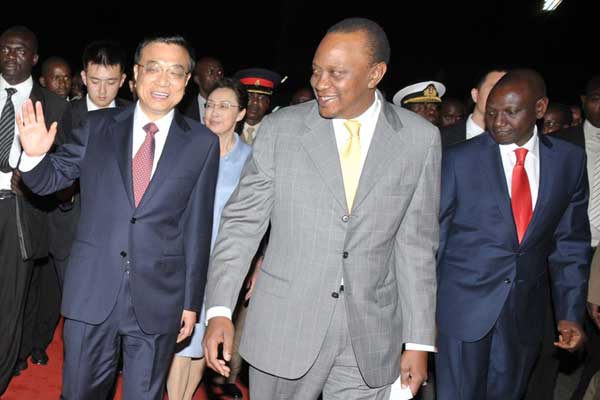President Uhuru Kenyatta receives Chinese Prime Minister Li Keqiang when he arrived at the Jomo Kenyatta International Airport on May 9, 2014 for a State visit. On his left is Deputy President William Ruto. PHOTO | PSCU