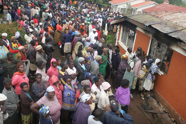 Grief-stricken mourners throng the home of Nyakach MP Aduma Owuor’s parents on November 8, 2013. The Nyakach MP uses more than 20 different types of cars in a month, including a hearse, in a desperate attempt to hide his identity whenever he visits his rural home in Nyakach, Kisumu. PHOTO | TON OTIENO | FILE