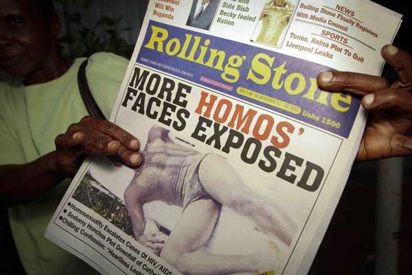 A Ugandan street newspaper vendor holding a copy of The Rolling Stone newspaper, which has no relation to the US magazine, in Kampala on November 2, 2010. The newspaper on November 1 published the names and photos of 14 men it identified as gay. PHOTO | MARC HOFER | FILE