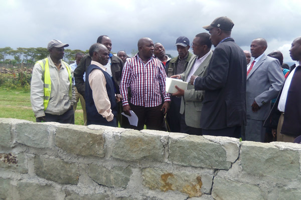 Laikipia East MP Anthony Mutahi (in striped shirt) during the inspection of a classroom under construction at Kariguini Secondary School in his constituency. The construction is being funded by the area CDF kitty. Mr Mutahi has criticised the devolved governments saying they have not benefited Kenyans. He said CDF allocations were only 2.5 per cent of the national revenue and have done marvelous work while counties get 40 per cent with very little to show for it. PHOTO/MUCHIRI GITONGA.