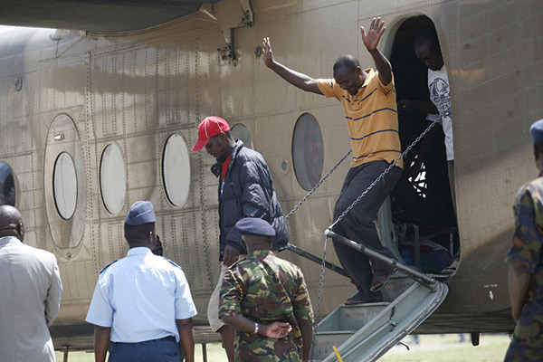 Some of the  Kenyans who were evacuated from South Sudan disembarks from a Kenya Defence Forces plane at Wilson Airport after their evacuation on December 30, 2013. Photo/EVANS HABIL