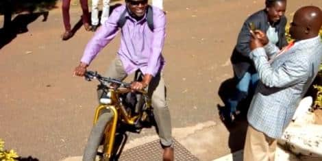 Okoth Obado Rides Bicycle