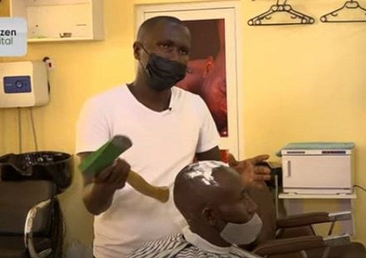 Kenyan barber Julius Mwangi Who uses an axe to cuts hair